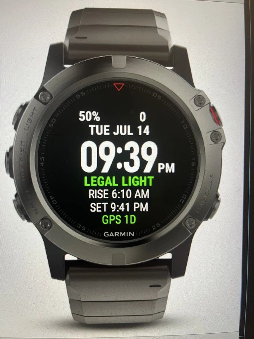 Garmin watch displaying the Maclyn watch face with green LEGAL LIGHT and sunrise and sunset times